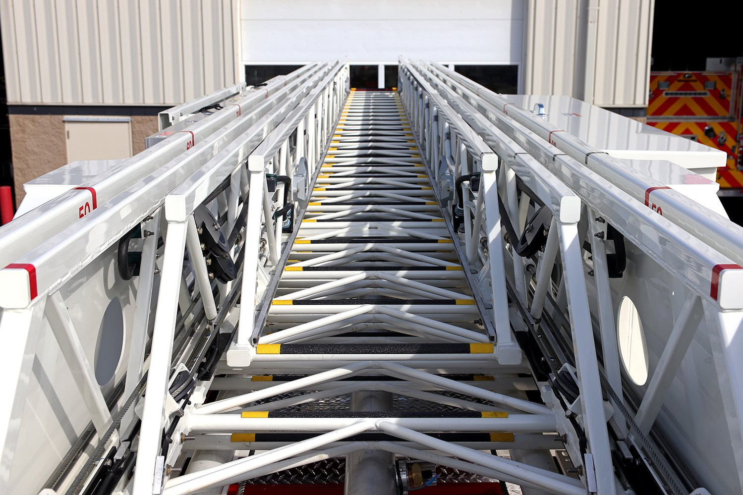 View looking across the ladder of a 100' Heavy-Duty Low Profile Steel Aerial Ladder truck.
