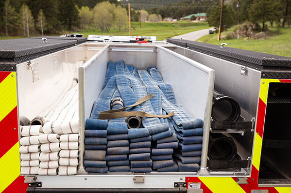 Hose stored in pumper fire truck hose bed 