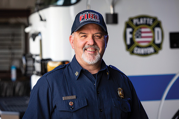 Fire Chief posing in front of Pierce PUC Pumper Fire Truck