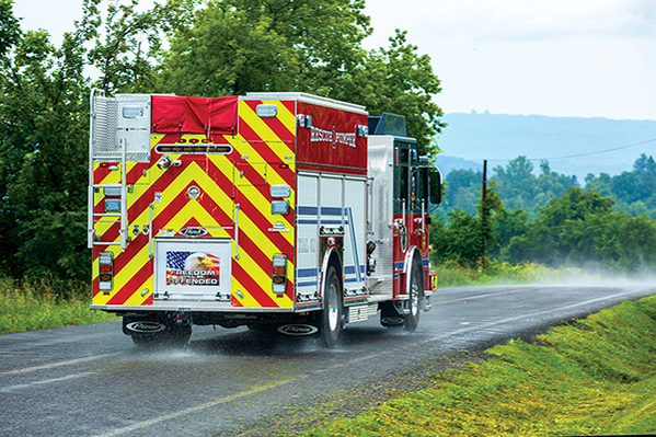 Heavy-Duty Rescue Pumper Fire Truck Driving on Foggy Road