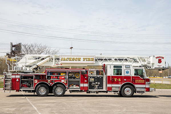 Aerial Platform Fire Truck officers side compartments open with equipment loaded