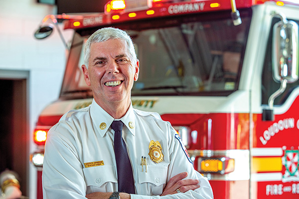 Loudoun County Fire Chief standing in front of his new Pierce pumper fire truck