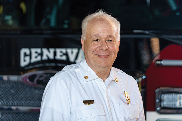 Geneva Illinois Fire Department Chief in front of their Ascendant 110 Aerial Platform Fire Truck