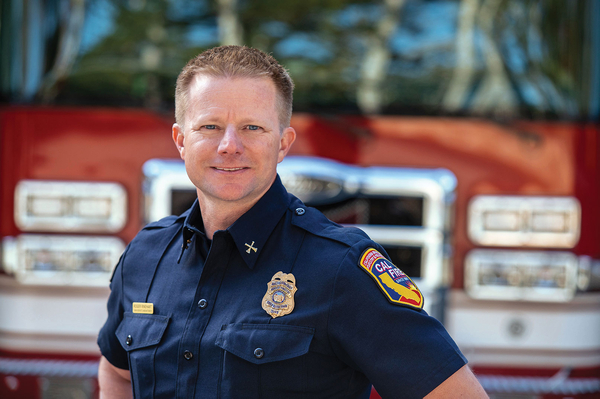 CAL Fire Chief in front of Pierce pumper fire truck