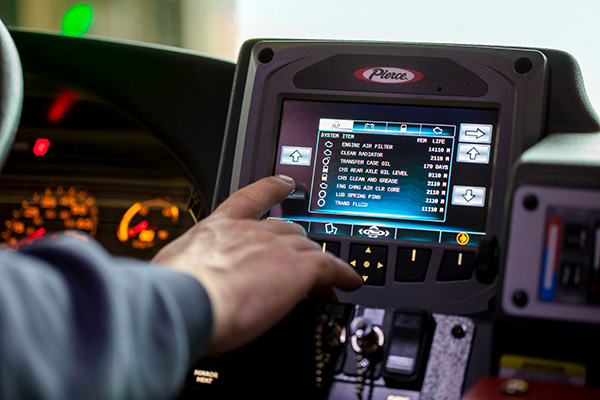 Firefighter pressing buttons on the Command Zone™ Electrical Systems on the interior of a Pierce Fire Truck. 