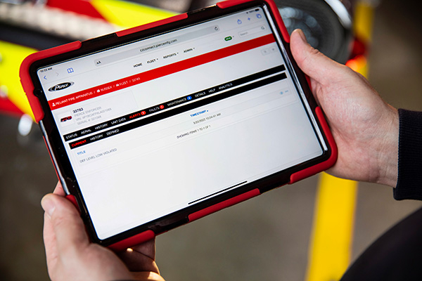 A Firefighter remotely accessing fire apparatus data through a tablet using the ClearSky™ web-portal. 