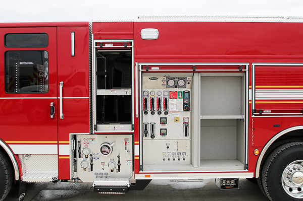 Officer’s side of a Pierce PUC™ Fire Truck side panel and storage compartments open. 