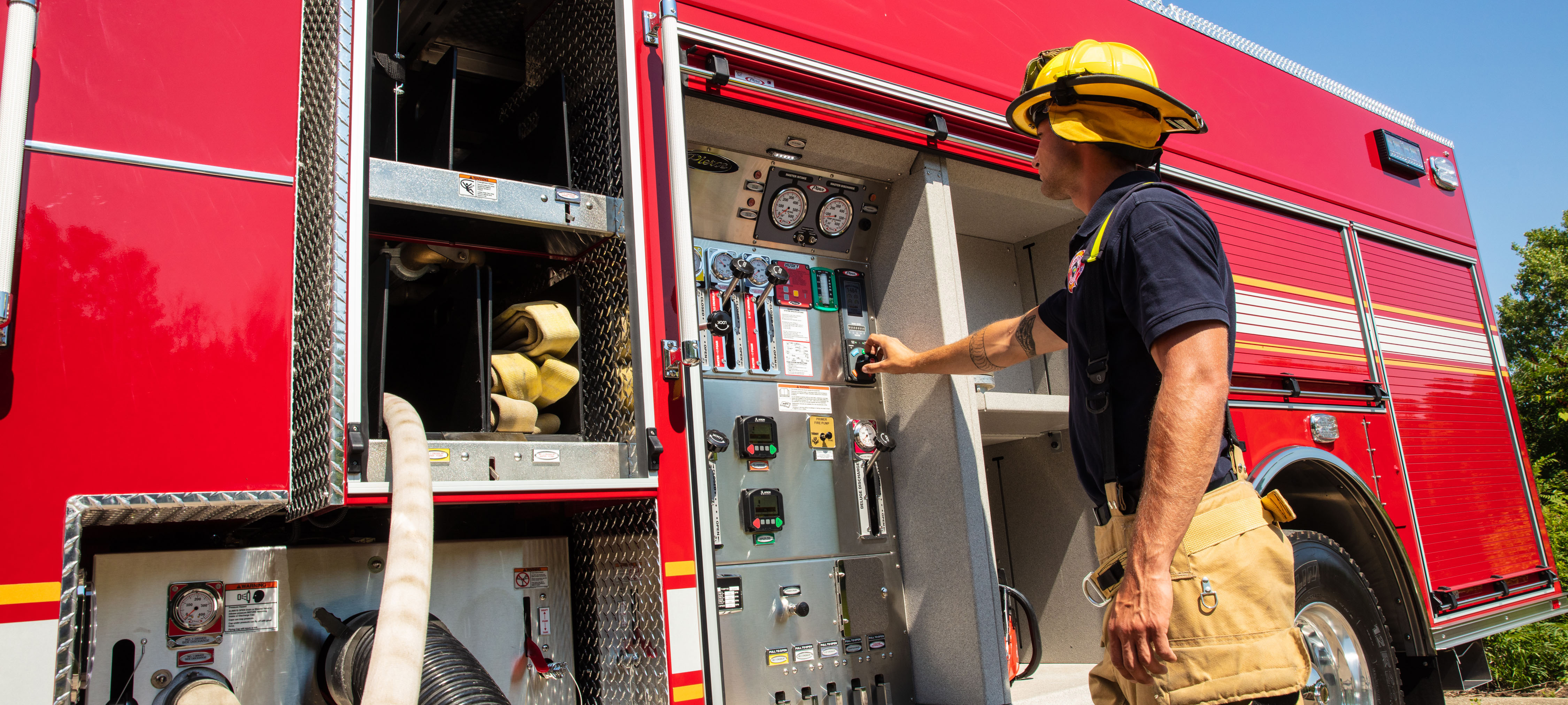 Firefighter engineer pumping at pump panel