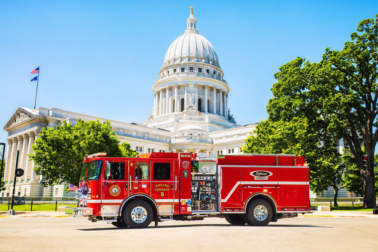 Pierce Volterra Electric firetruck for Madison Fire Department parked outside on a sunny day in front of the Wisconsin State Capital Building. 