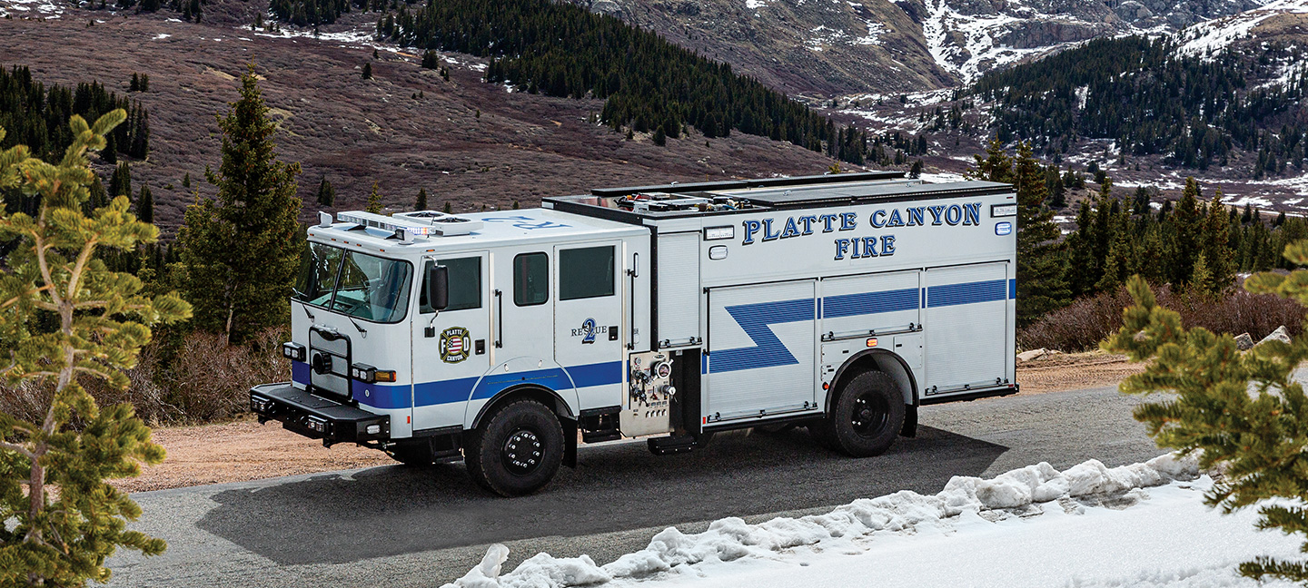 Pumper fire truck parked in mountain range